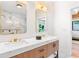 Modern bathroom featuring a double vanity, marble accents, and a shower with a glass enclosure at 5370 Greenleaf Sw Dr, Mableton, GA 30126