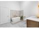 Spa bathroom featuring a soaking tub, modern fixtures, and stylish tile work at 5370 Greenleaf Sw Dr, Mableton, GA 30126