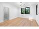 Bright bedroom featuring hardwood floors, modern light fixture and large windows with natural light at 5370 Greenleaf Sw Dr, Mableton, GA 30126
