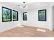 Bright bedroom featuring hardwood floors, modern light fixture and large windows with natural light at 5370 Greenleaf Sw Dr, Mableton, GA 30126