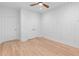 Bedroom features wood floors, geometric accent wall, and double-door closet providing ample storage space at 5370 Greenleaf Sw Dr, Mableton, GA 30126