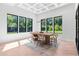 Well-lit dining room with views of the outdoors, decorative ceiling, and natural wood floors at 5370 Greenleaf Sw Dr, Mableton, GA 30126