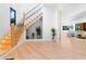 Elegant foyer with a staircase, wood floors, and seamless transition to the living space, featuring modern decor at 5370 Greenleaf Sw Dr, Mableton, GA 30126