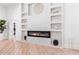 Modern living room with a fireplace, custom shelving, and seamless flow to the outdoor patio, enhancing the living experience at 5370 Greenleaf Sw Dr, Mableton, GA 30126