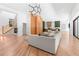 Expansive living room with hardwood floors, modern lighting, open floor plan, and seamless flow to the kitchen at 5370 Greenleaf Sw Dr, Mableton, GA 30126