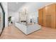 Bright, open living room with modern fireplace, wood accent wall, light hardwood floors and stylish lighting at 5370 Greenleaf Sw Dr, Mableton, GA 30126