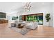 Open-concept living space featuring a large sectional sofa, modern lighting, and seamless access to the backyard patio at 5370 Greenleaf Sw Dr, Mableton, GA 30126