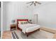 Bright bedroom featuring a white accent wall, ceiling fan, modern décor, and wood flooring at 5370 Greenleaf Sw Dr, Mableton, GA 30126