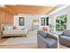 Bright main bedroom featuring a seating area, wood floors, wood ceiling, and access to a private deck at 5370 Greenleaf Sw Dr, Mableton, GA 30126