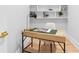 Stylish home office with built in shelves, modern desk with black metal legs and light wood flooring at 5370 Greenleaf Sw Dr, Mableton, GA 30126