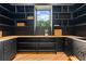 Walk-in pantry with dark custom cabinetry, butcher block countertops, and a window with a view at 5370 Greenleaf Sw Dr, Mableton, GA 30126