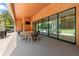 Covered patio features a wood ceiling, an outdoor dining set, and sliding glass doors to backyard at 5370 Greenleaf Sw Dr, Mableton, GA 30126
