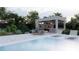 Relaxing poolside view featuring a modern outdoor kitchen, dining area, and comfortable lounge chairs at 5370 Greenleaf Sw Dr, Mableton, GA 30126