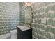 Stylish powder room with modern fixtures, patterned wallpaper, and a sleek vanity at 5370 Greenleaf Sw Dr, Mableton, GA 30126