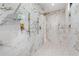Stunning shower with marble-patterned tile and gold hardware, and a modern shower head fixture at 5370 Greenleaf Sw Dr, Mableton, GA 30126