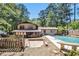 Backyard featuring a pool and patio area with mature trees and landscaping at 5491 Valley Brook Road Southeast Se Rd, Mableton, GA 30126
