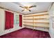 Spare bedroom with open wood shelving, neutral walls, and a ceiling fan at 5491 Valley Brook Road Southeast Se Rd, Mableton, GA 30126