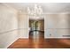 Dining room featuring hardwood floors, a chandelier, and view of the kitchen through an open doorway at 5491 Valley Brook Road Southeast Se Rd, Mableton, GA 30126