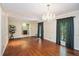 Dining room with hardwood floors, chandelier, and natural light from the large window creates a warm atmosphere at 5491 Valley Brook Road Southeast Se Rd, Mableton, GA 30126