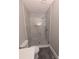 Modern bathroom featuring a marble-tiled walk-in shower with glass doors at 8239 High Lake Ter, Covington, GA 30014