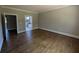 Expansive bedroom showcasing hardwood floors, and doorways to ensuite bathroom at 8239 High Lake Ter, Covington, GA 30014