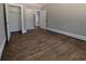 Bedroom with hardwood floors and neutral paint, including two closets and a window at 8239 High Lake Ter, Covington, GA 30014