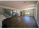 Spacious living room featuring hardwood flooring, a staircase, and open access to the modern kitchen at 8239 High Lake Ter, Covington, GA 30014