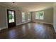 Sun-filled living room featuring hardwood floors, large windows, and neutral tones, perfect for comfort at 8239 High Lake Ter, Covington, GA 30014