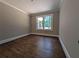 A versatile room featuring hardwood floors, neutral paint, and natural light from a window at 8239 High Lake Ter, Covington, GA 30014