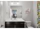 Well-lit bathroom features a modern vanity with white countertop and decorative giraffe art at 914 Martin Nw St, Atlanta, GA 30315