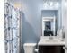 Comfortable bathroom with a decorative shower curtain, sink, and large mirror at 914 Martin Nw St, Atlanta, GA 30315