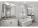 Modern bathroom featuring double vanities, granite countertops, and a luxurious soaking tub at 914 Martin Nw St, Atlanta, GA 30315