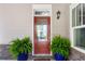 Charming home entrance with a red door, decorative plants, and stylish exterior lighting at 914 Martin Nw St, Atlanta, GA 30315