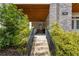 Inviting home entrance featuring steps, black railing, landscaped bushes, and address number 914 at 914 Martin Nw St, Atlanta, GA 30315
