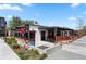 Charming Fox Bar & Bros exterior with inviting patio, outdoor games, and landscaping at 914 Martin Nw St, Atlanta, GA 30315