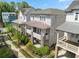 Exterior shot showcasing townhomes with covered patios, fenced yards, and attractive landscaping at 914 Martin Nw St, Atlanta, GA 30315