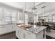 Open-concept kitchen featuring a granite island, stainless steel appliances, and seamless access to the dining and living areas at 914 Martin Nw St, Atlanta, GA 30315