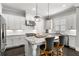 Well-lit kitchen featuring white cabinets, stainless steel appliances, and a granite-topped island with seating at 914 Martin Nw St, Atlanta, GA 30315