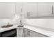 Elegant kitchenette with white cabinets, quartz countertops, and a stylish sink, providing a sleek and functional space at 914 Martin Nw St, Atlanta, GA 30315