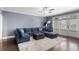 The cozy living room features a modern sectional sofa, and large windows at 914 Martin Nw St, Atlanta, GA 30315