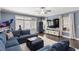 Open-concept living room with blue accents, entertainment center, and a view of the outdoor patio at 914 Martin Nw St, Atlanta, GA 30315