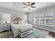 Spacious main bedroom featuring a decorative ceiling fan, large windows, and a stylish accent rug at 914 Martin Nw St, Atlanta, GA 30315