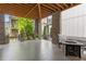 Relaxing covered patio with brick pillars, a sleek fire table, and serene outdoor ambiance at 914 Martin Nw St, Atlanta, GA 30315