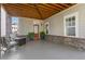 Spacious covered patio featuring brick accents, seating, and a cozy outdoor fireplace at 914 Martin Nw St, Atlanta, GA 30315