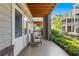 Inviting covered patio with French doors, comfortable seating, and lush green landscaping at 914 Martin Nw St, Atlanta, GA 30315