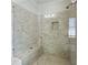 Modern shower with glass door, built-in bench, and neutral tile at 914 Martin Nw St, Atlanta, GA 30315