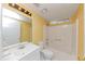 Bright yellow bathroom featuring a white shower-tub combo and a modern vanity at 916 Forest Pointe Way, Jonesboro, GA 30238