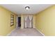 Bedroom featuring yellow walls, carpeted flooring, and a window with drapes at 916 Forest Pointe Way, Jonesboro, GA 30238