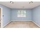 Cozy bedroom featuring neutral carpet, a window for natural light, and outlets at 916 Forest Pointe Way, Jonesboro, GA 30238