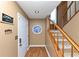 Inviting entryway with wood floors, staircase, and decorative stained-glass window at 916 Forest Pointe Way, Jonesboro, GA 30238